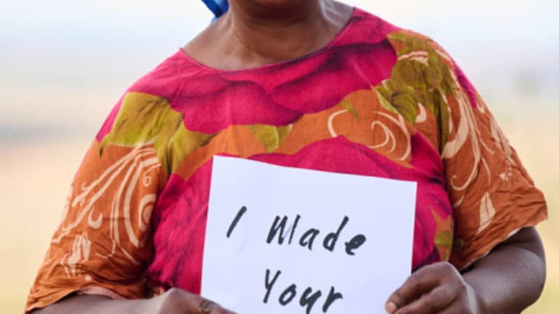 The Basket Room Kenyan Basket Weaver Holding I Made Your Basket Sign
