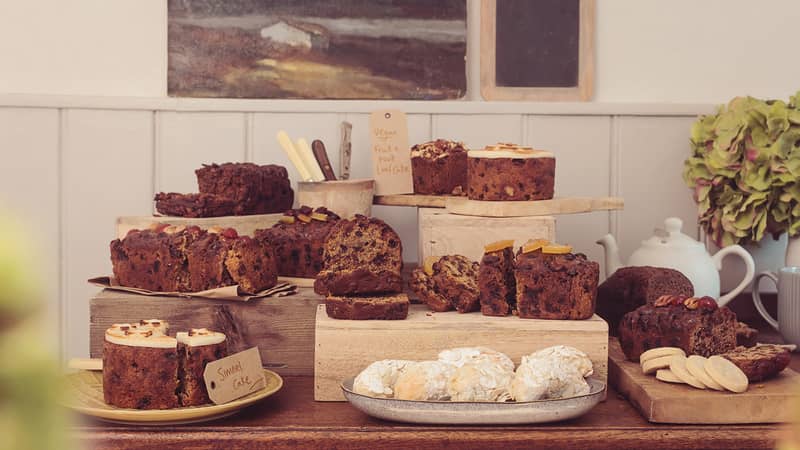 A variety of cakes, including fruit cakes in a display