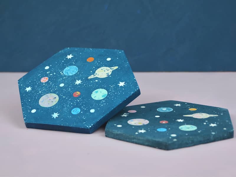 A hexagon trinket tile with all of the planets in it and stars by Astral Tides