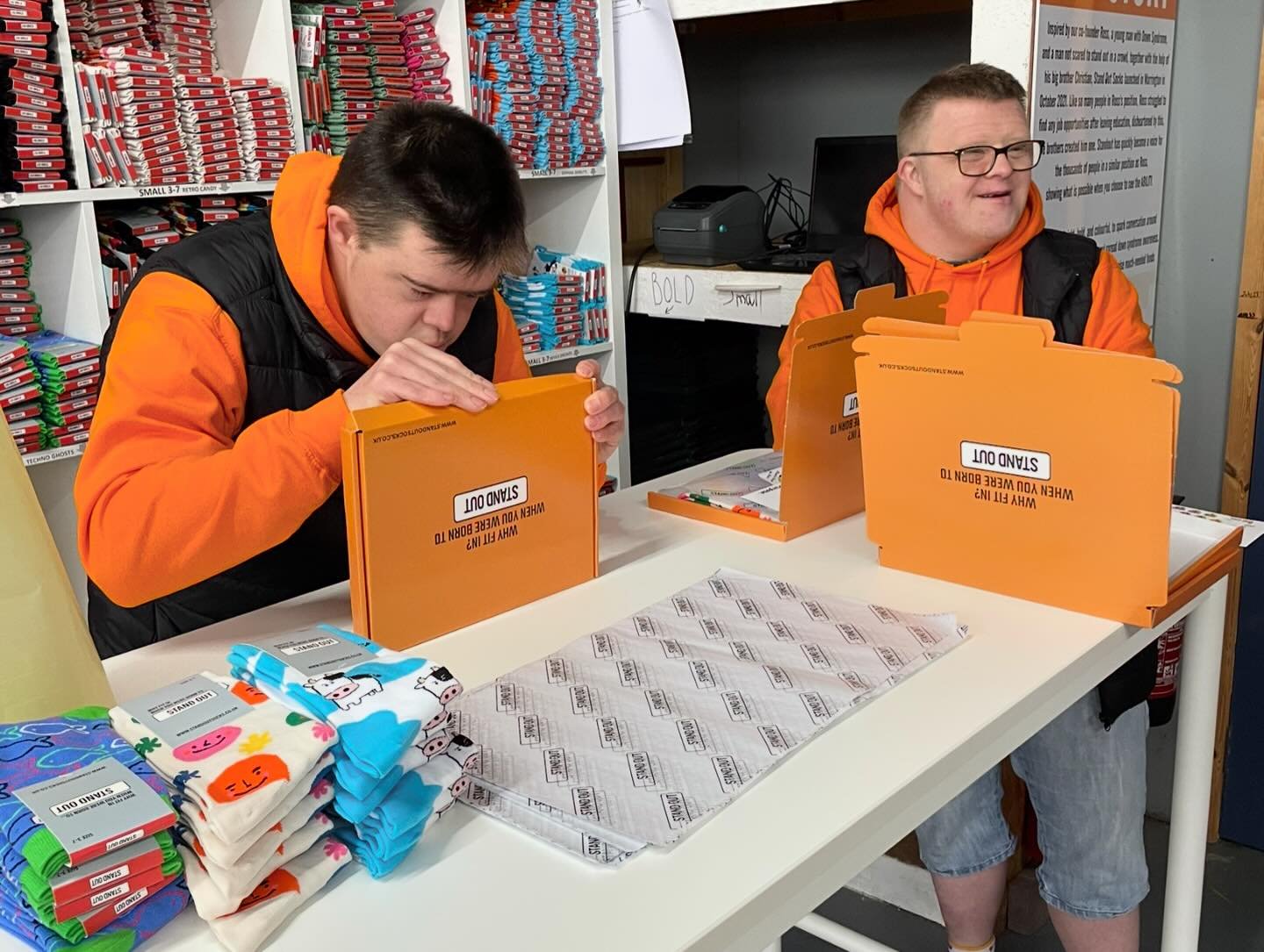 Stand Out Socks team members working hard to personally packing orders.