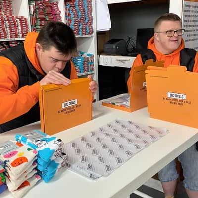 Stand Out Socks team members working hard to personally packing orders.