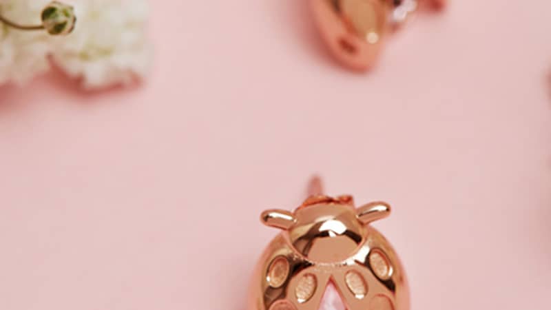 Ladybird earrings made from recycled silver and plated with 18ct rose gold with a Swarovski crystal.