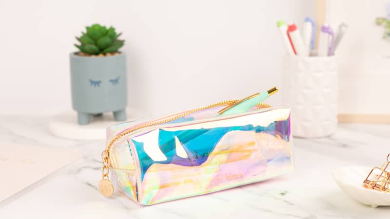 Coral and Ink's clear holographic study pencil case on a study desk surrounded by Zebra Mildliner Highlighter Pens