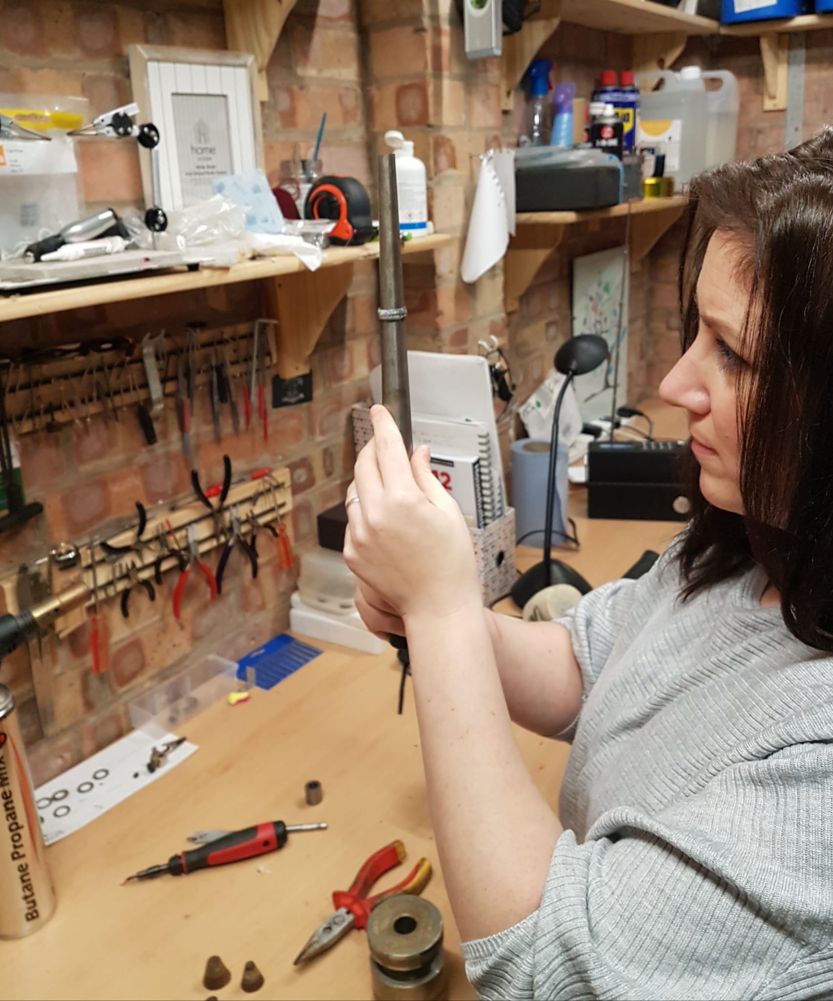Katie studying a ring on the mandrel