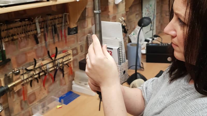 Katie studying a ring on the mandrel