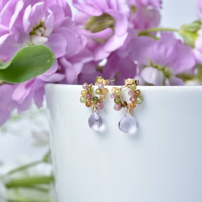 An image of dainty and delicate tourmaline and pink amethyst drop earrings from the brand mamie coco atelier