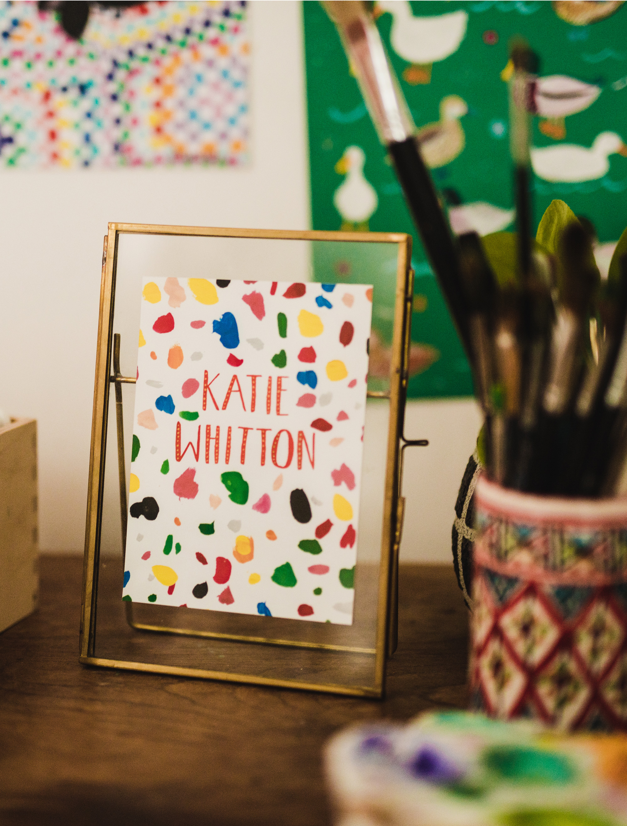 Katie Whitton Logo in a work setting