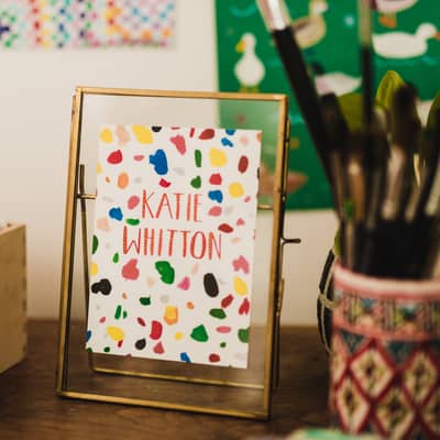 Katie Whitton Logo in a work setting