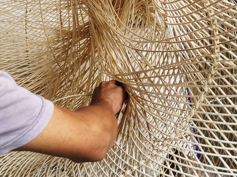 Rattan weaver making lampshade