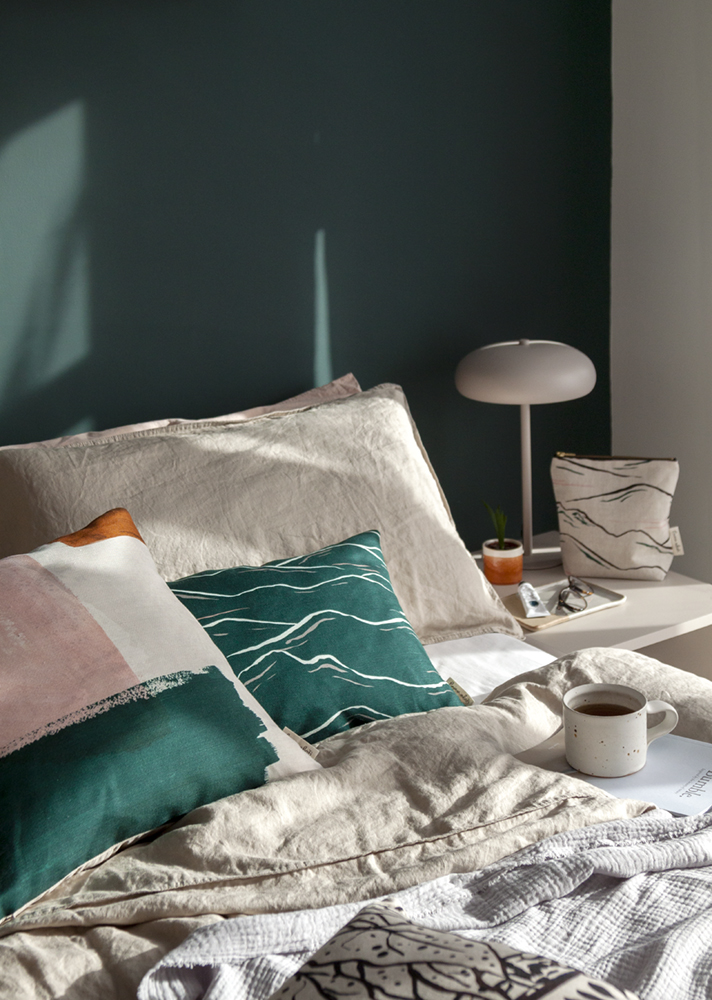 A relaxing bedroom scene featuring Emma's cushions and wash bag.