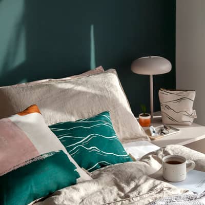 A relaxing bedroom scene featuring Emma's cushions and wash bag.