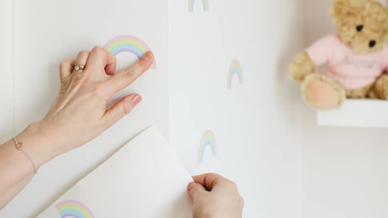 Applying rainbow wall stickers