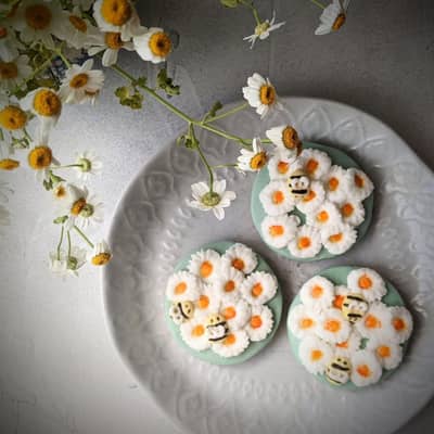 Plate of our hand iced daisy biscuits