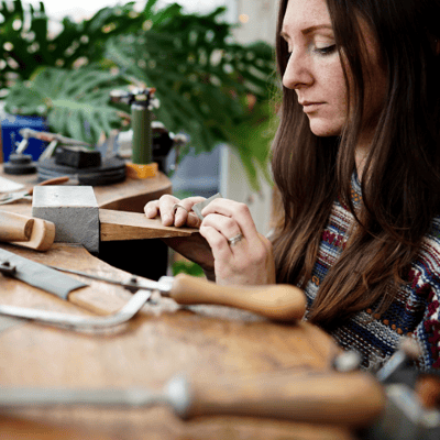 Kate wainiwrght making jewellery at her workbench
