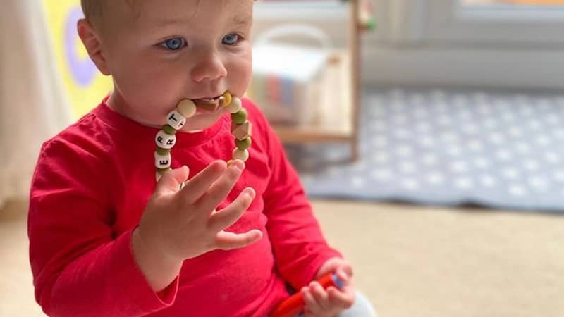 Baby enjoying a Lily & Posie teething ring