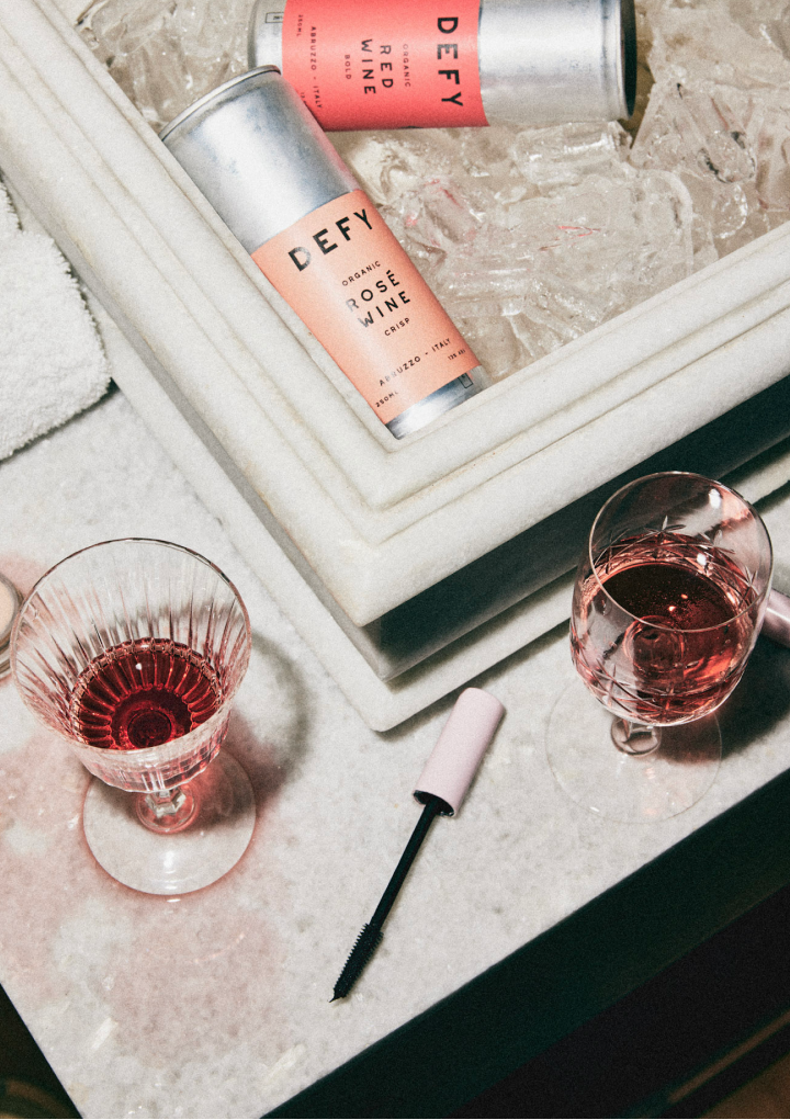 Cans of DEFY organic wine in a marble sink full of ice