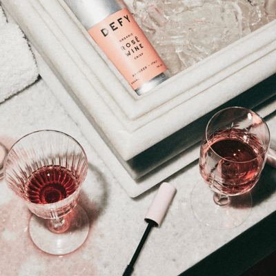 Cans of DEFY organic wine in a marble sink full of ice
