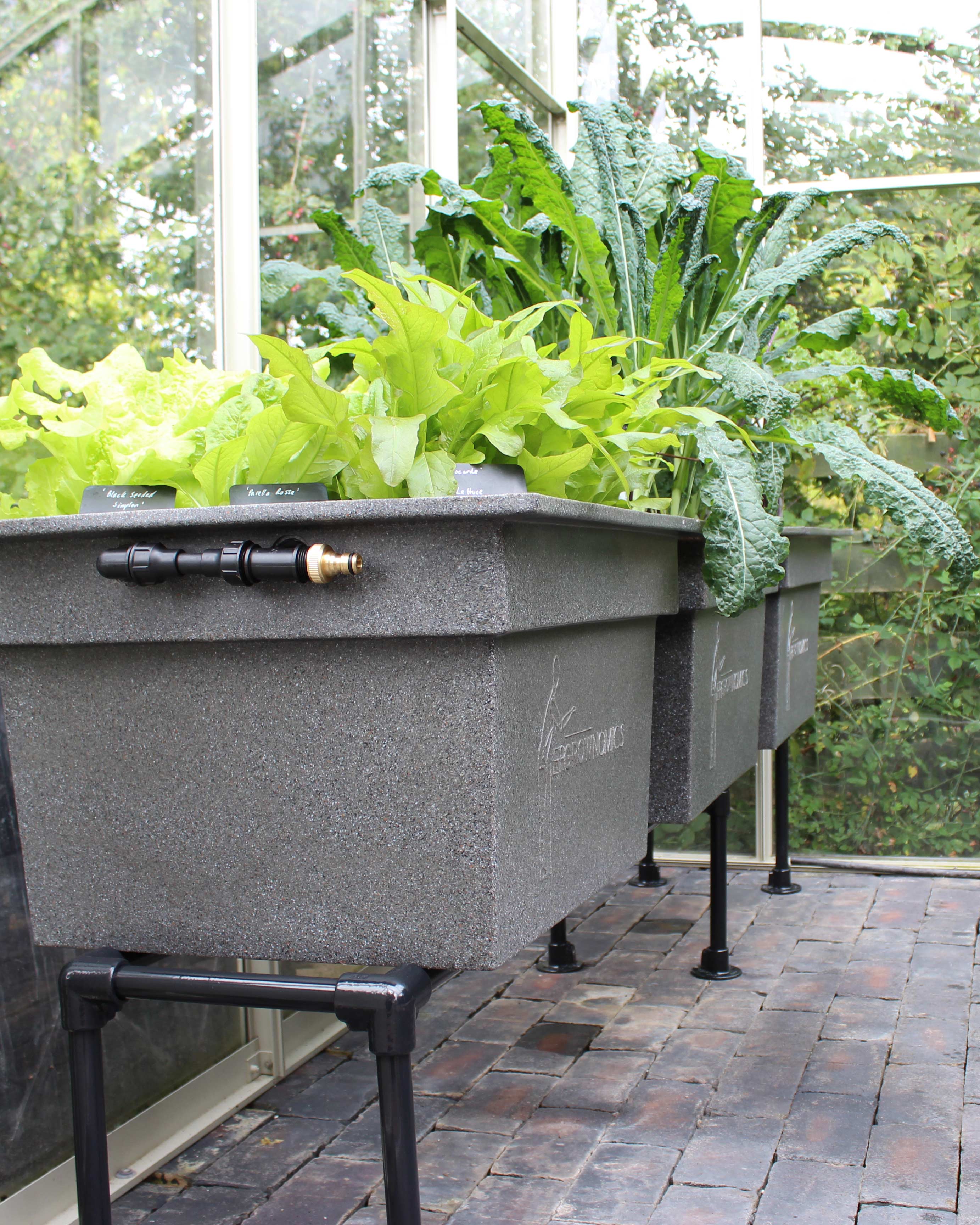Raised planters forming an interior greenhouse kit
