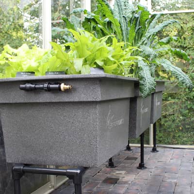 Raised planters forming an interior greenhouse kit