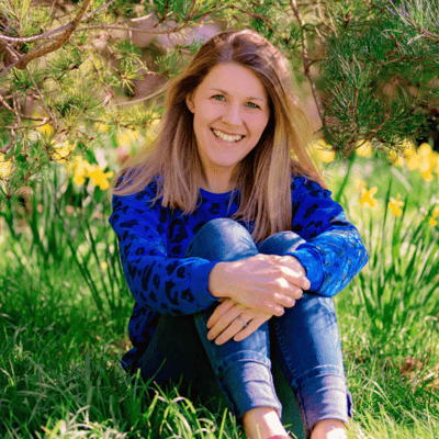 Image of Ducky Zebra founder, Sally Dear, sitting in the grass