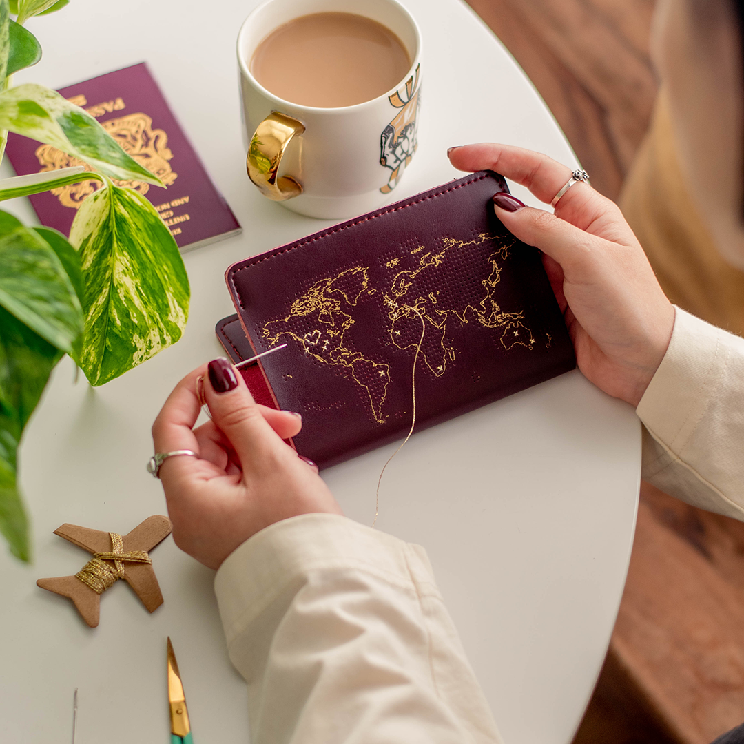 Stitch Your Travels Maroon Passport Cover being stitched by Chasing Threads