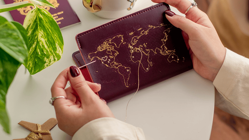Stitch Your Travels Maroon Passport Cover being stitched by Chasing Threads