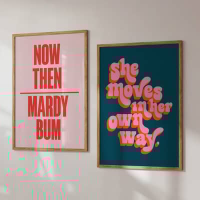 Two colourful posters in frames