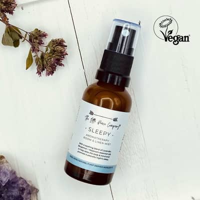 A glass bottle containing an aromatherapy pillow spray named Sleepy