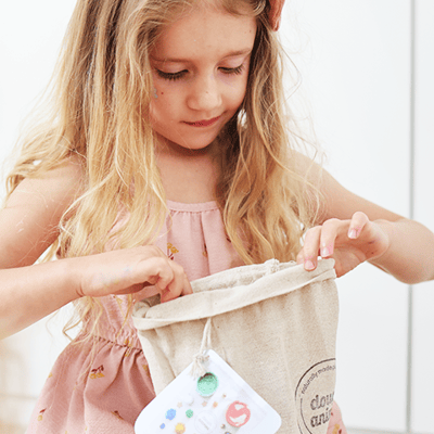Excited girl with glitter birthday play dough
