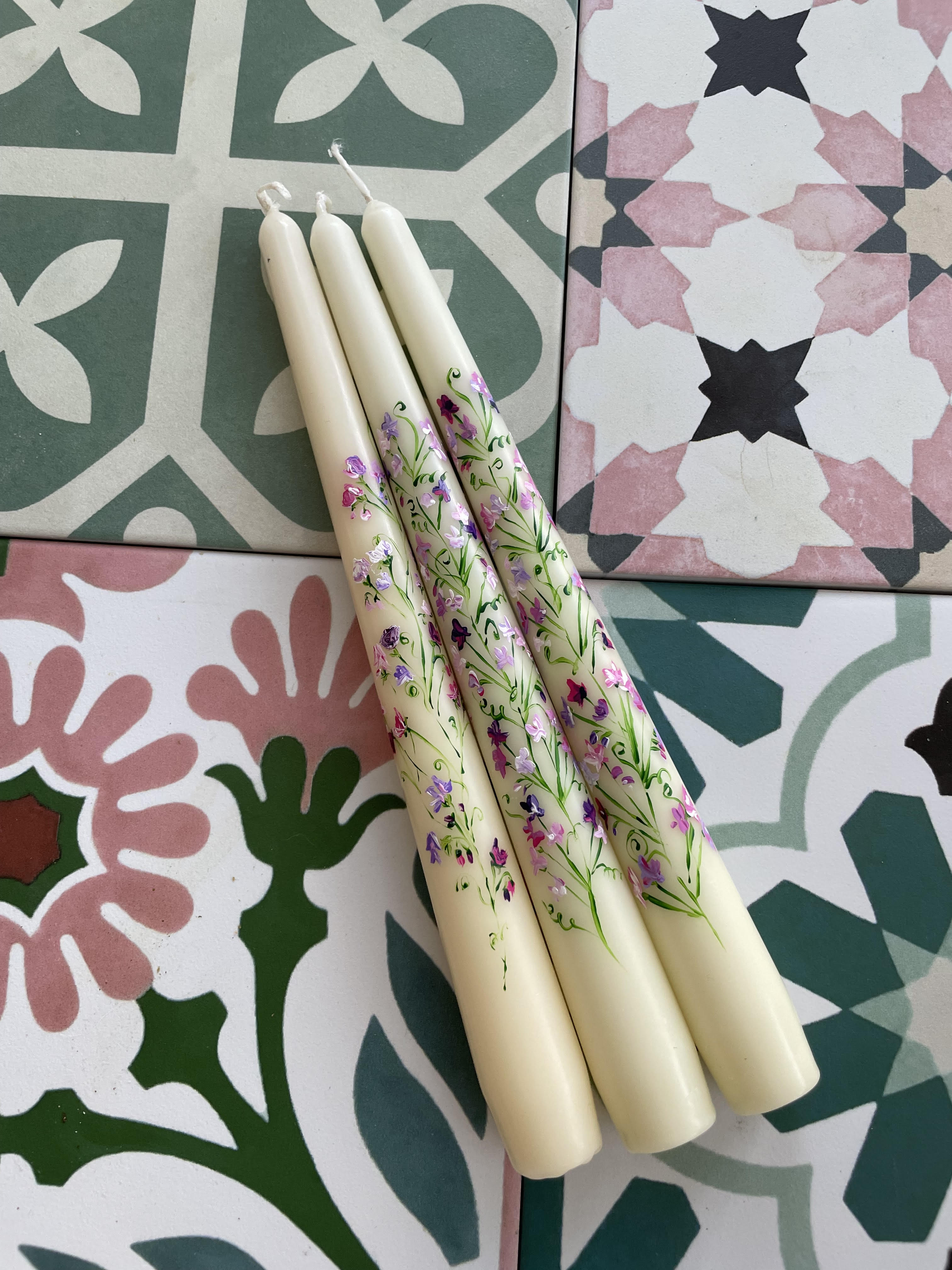 Set of candles on floral tiles