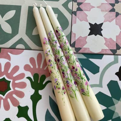 Set of candles on floral tiles