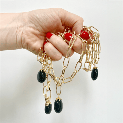 Handful of gold and onyx necklaces