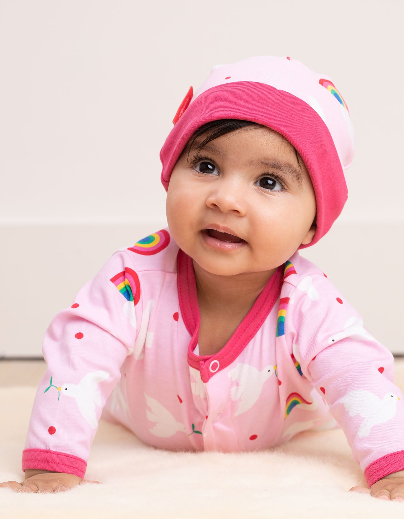 A baby lying on it's belly wearing a Organic Baby Gift Set - Dove Print