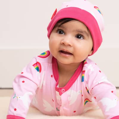 A baby lying on it's belly wearing a Organic Baby Gift Set - Dove Print