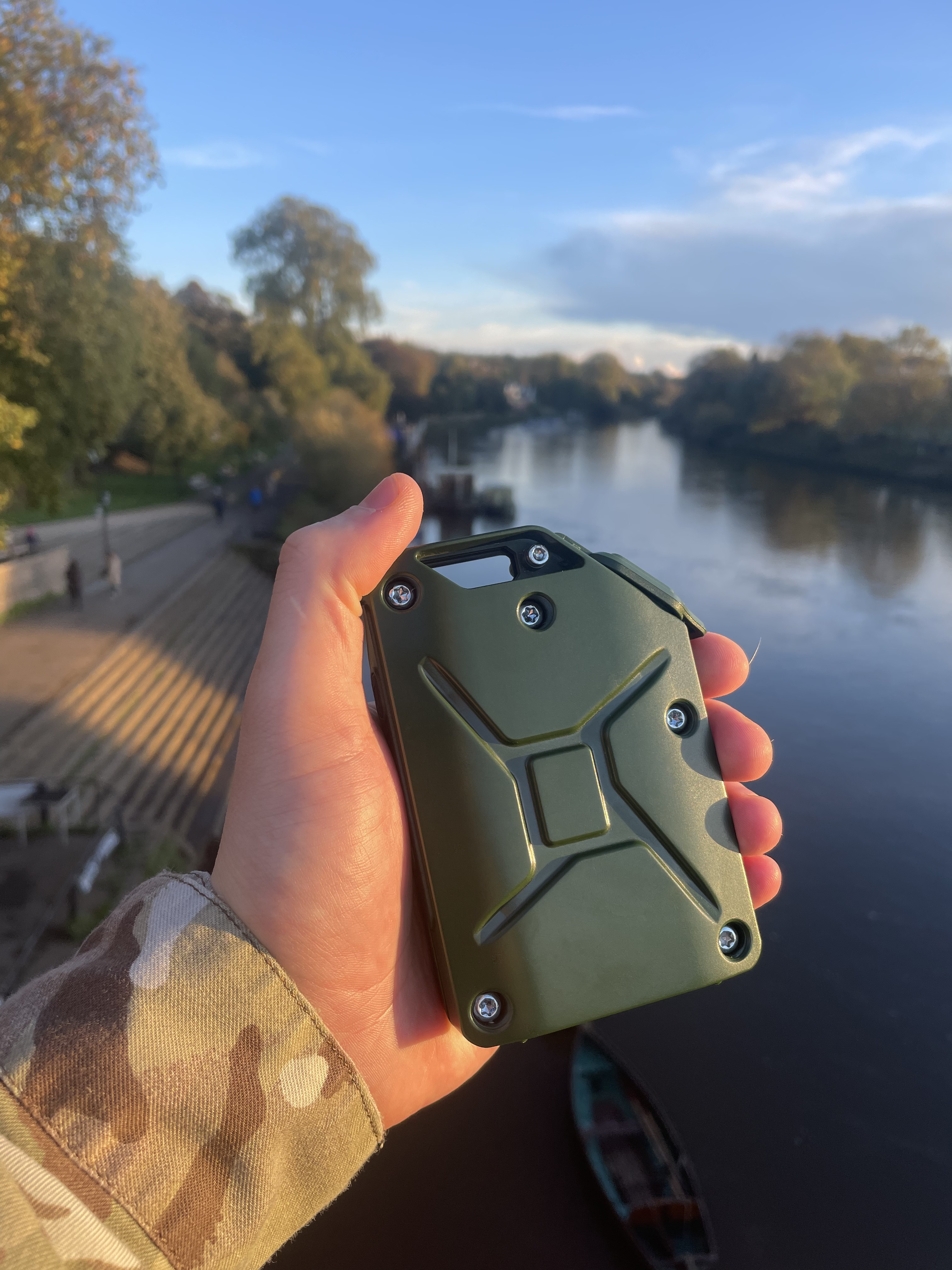 Hand holding an Olive Green charger