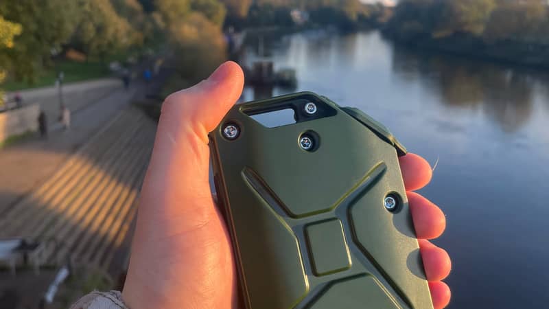 Hand holding an Olive Green charger