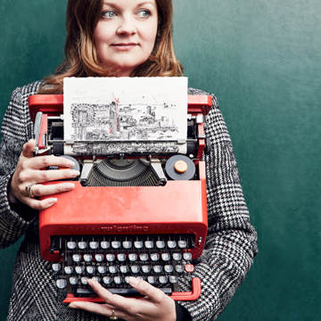 Keira Rathbone typewriter artist typing from life finger on typewriter key tower bridge in the background, typing of tower bridge on the typewritten page