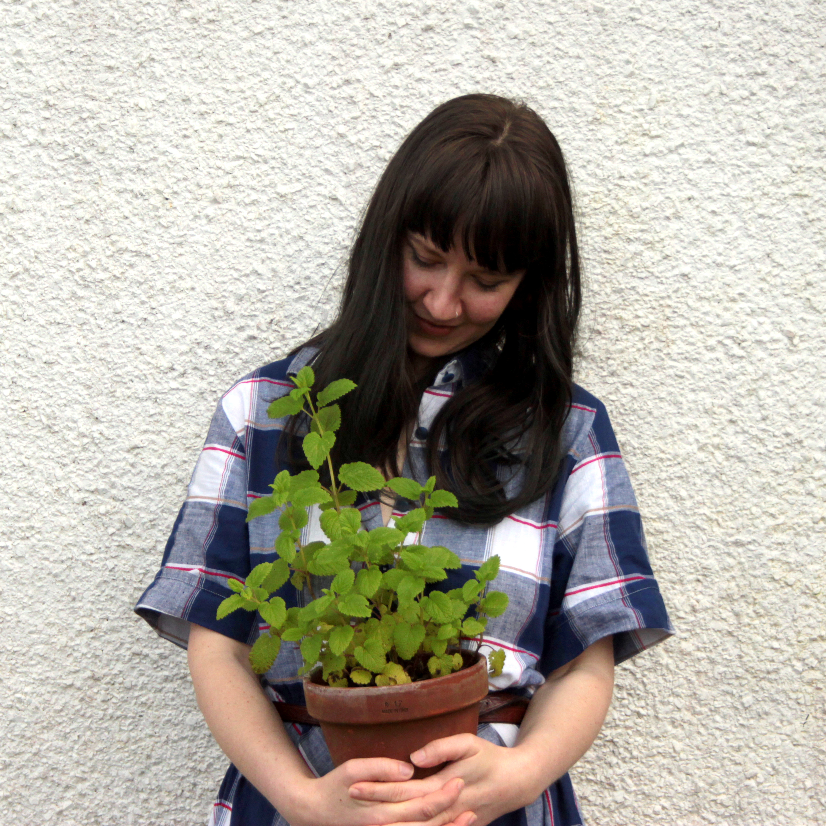 woman holding potted plant