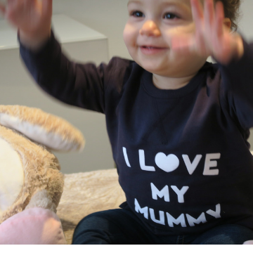 Gorgeous pink and white striped baby grow, personalised with your baby's name.