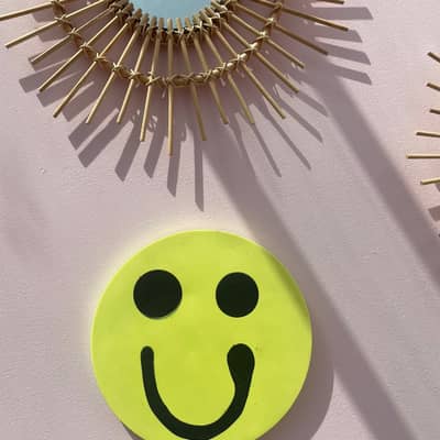 smiley neon yellow wall hanging