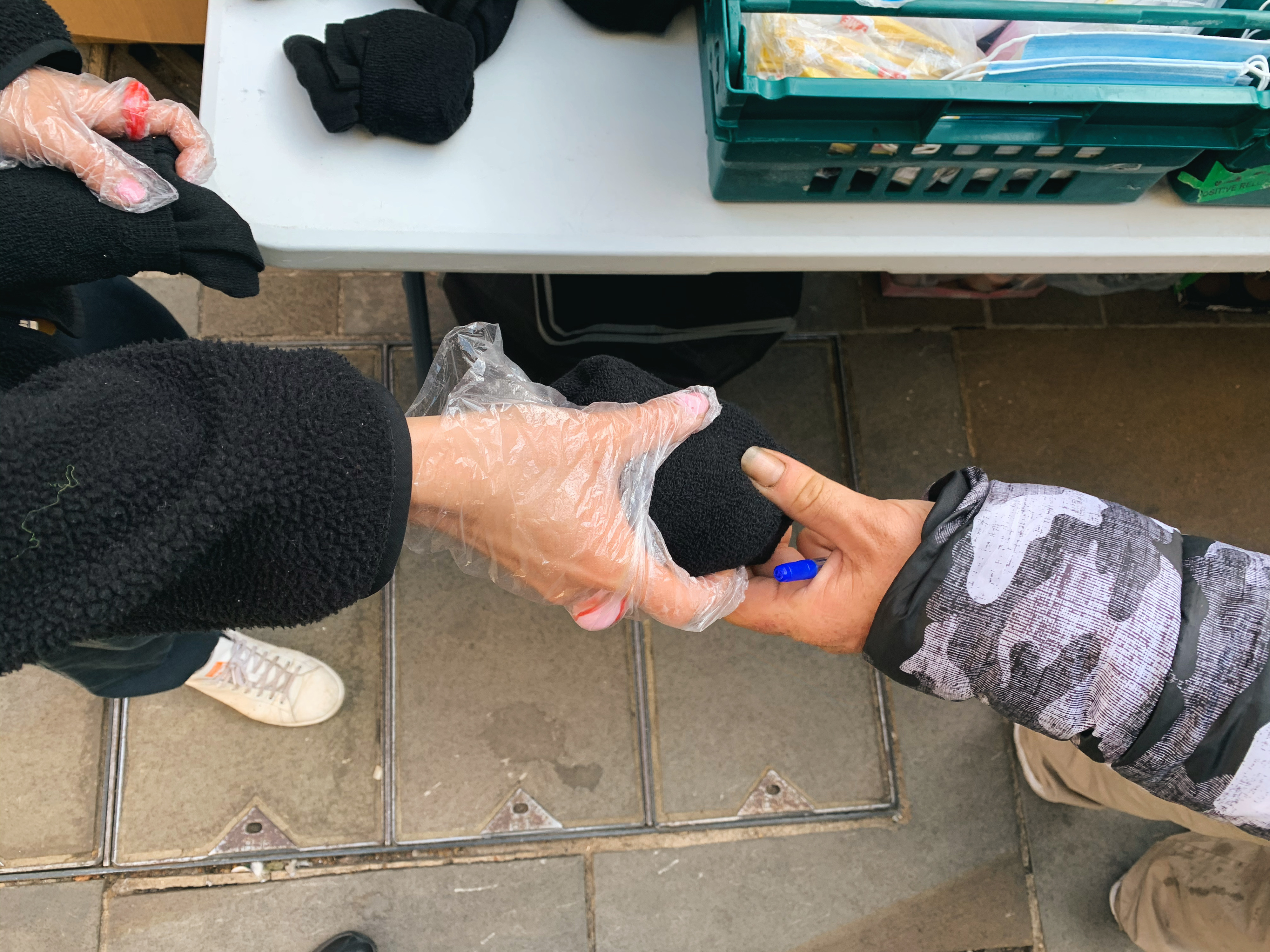 The Leiho team giving out socks to someone in need