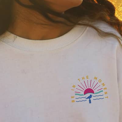 girl wearing Be in the Moment crew sweat