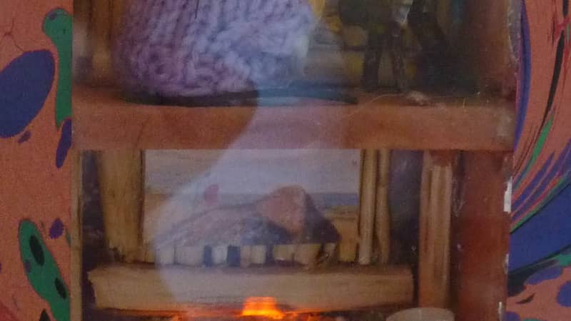 Miniature mouse house in a book,with a flickering fire and candle. This is the perfect nightlight