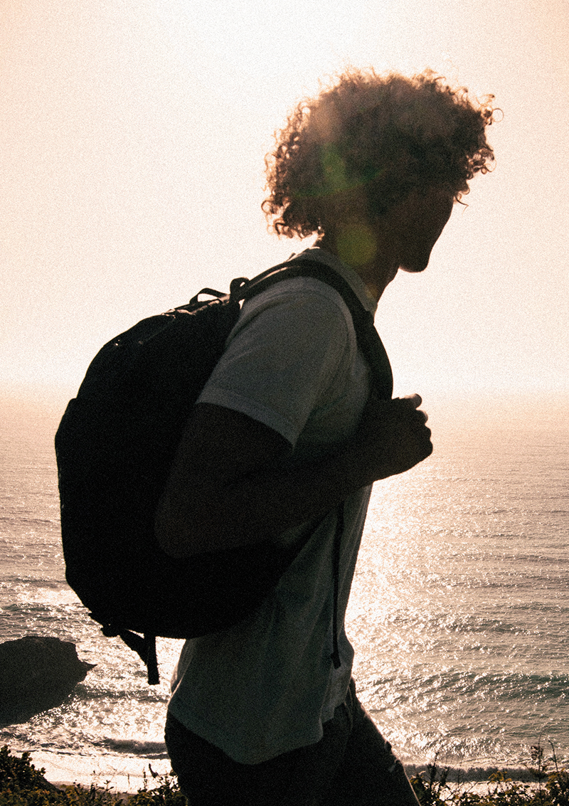 surfer wearing t-shirt and backpack