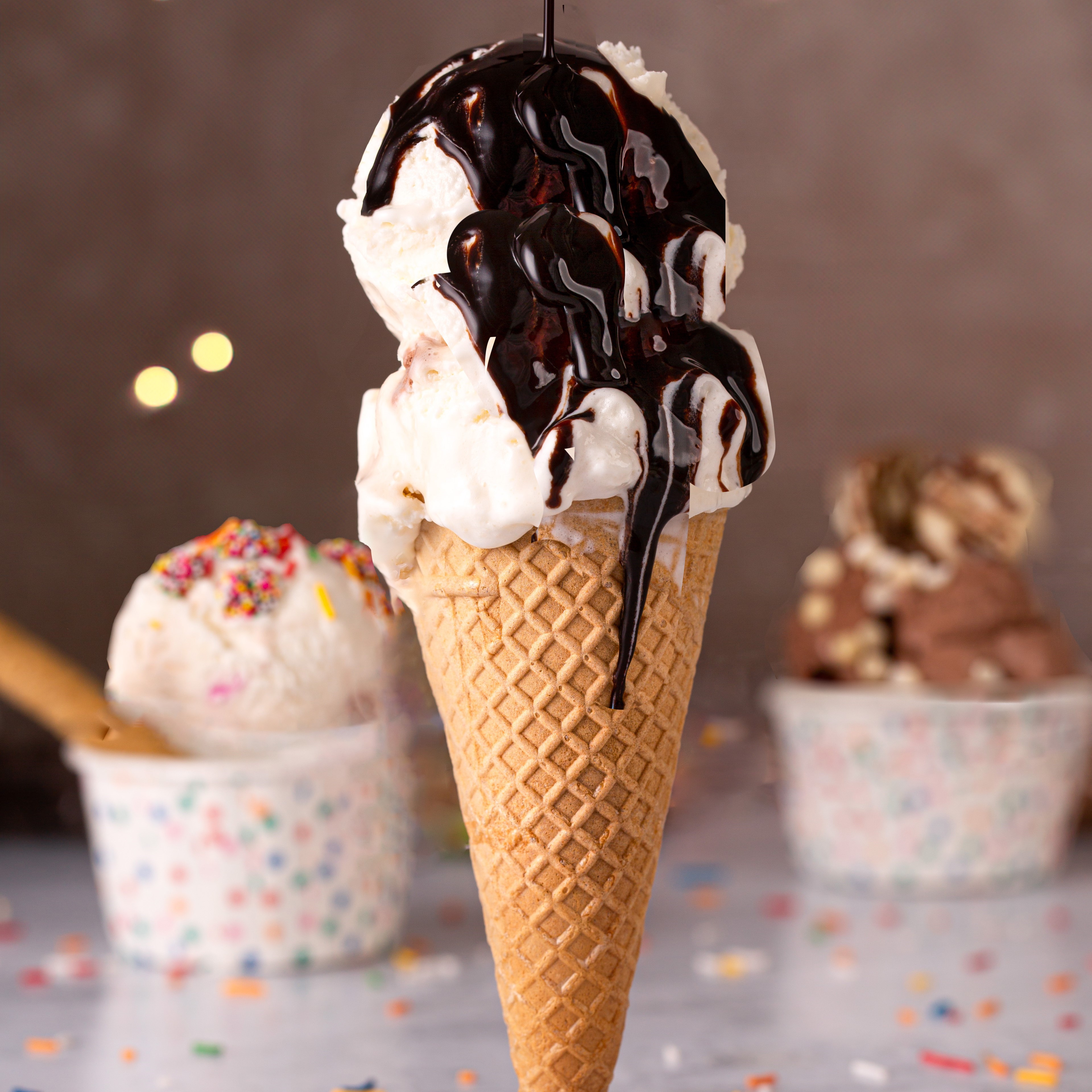 Dripping ice creams in cups and a cone