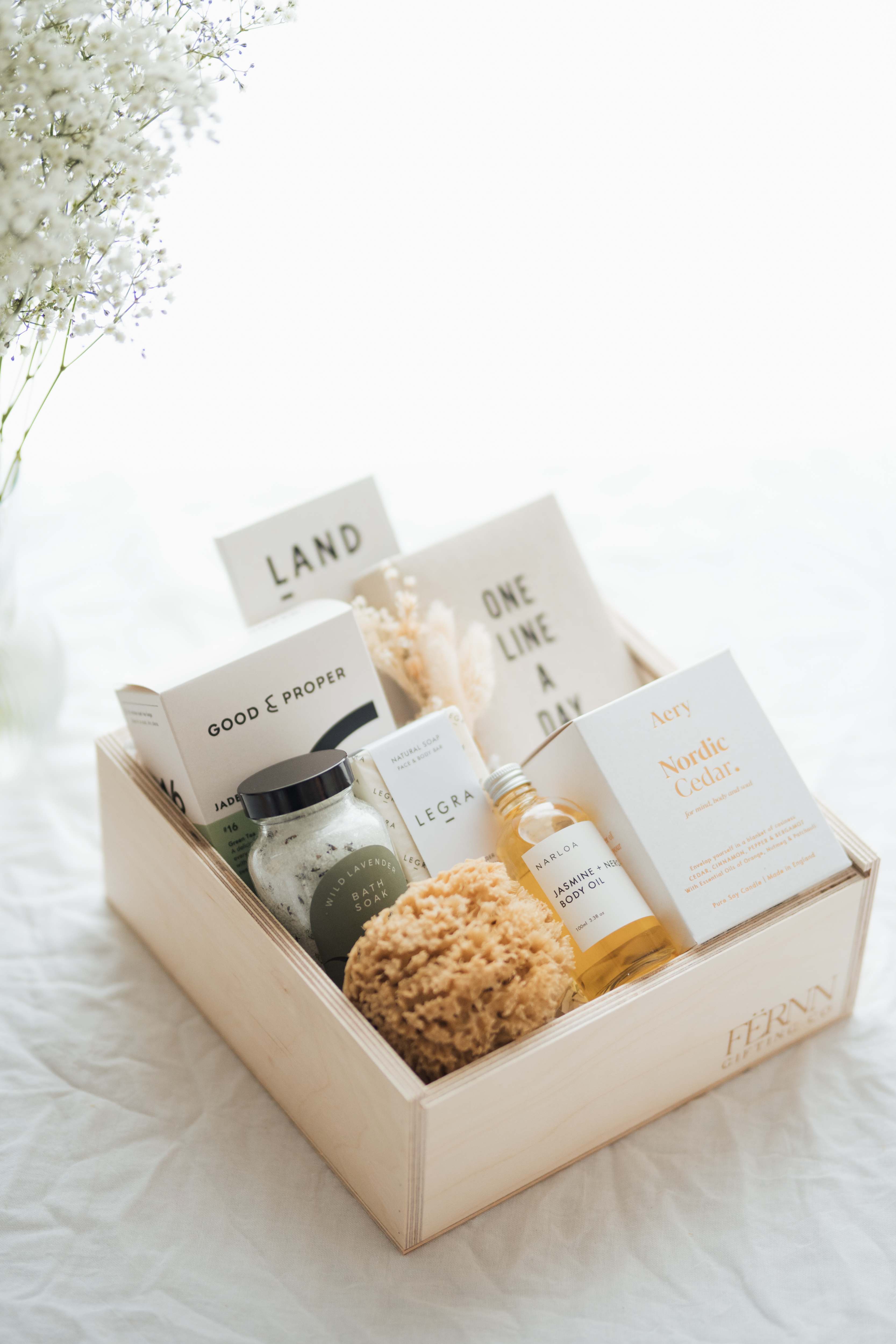 FERNN Gifting Co Founder Coco holding a mug leaning against the window looking at the camera