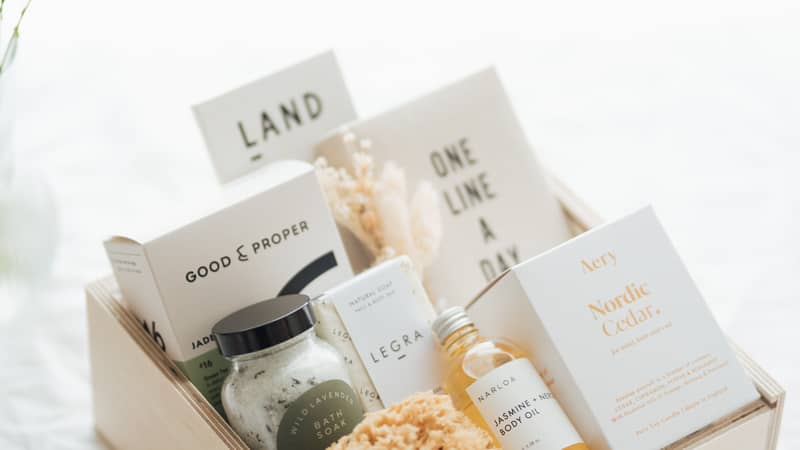 FERNN Gifting Co Founder Coco holding a mug leaning against the window looking at the camera