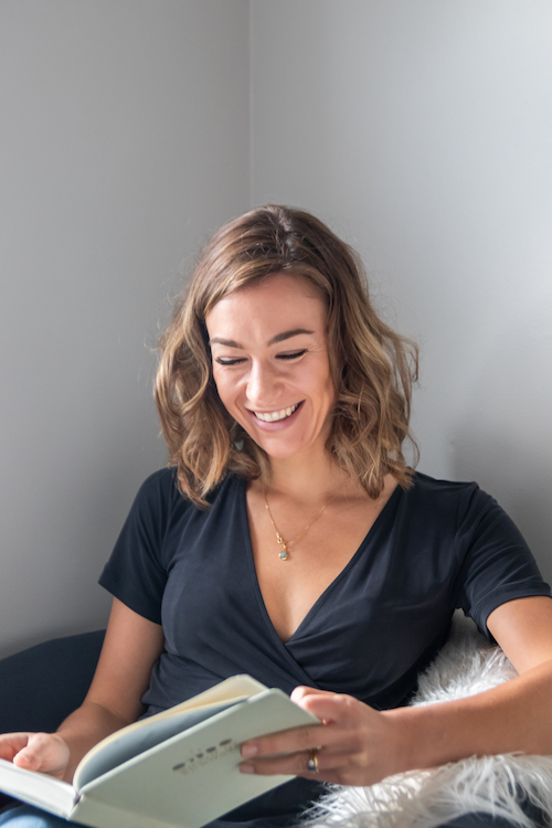 Woman holding Month of Sundays Journal