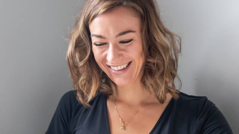 Woman holding Month of Sundays Journal