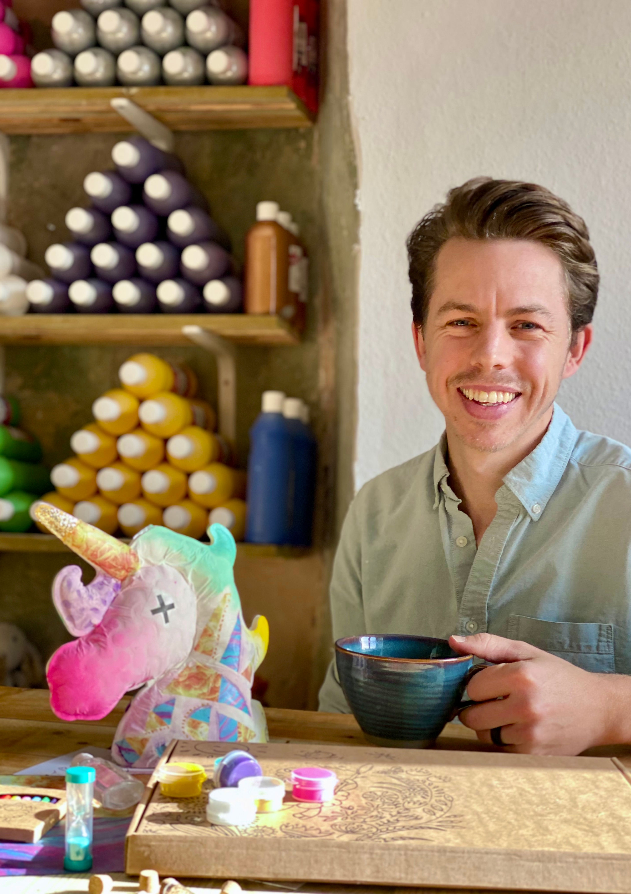 Founder, Ben Strange, in the workshop with a completed unicorn model.